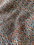 Close up view highlighting the floppy handle and low worn pile of antique Afshar rug.