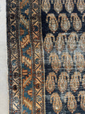 Border bands with small botanical designs surrounding the main field.