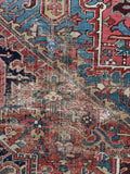 Close-up view of an antique Persian rug with worn character.