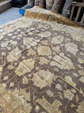 Subtle color variation in vintage Agra rug under natural light.