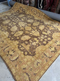 Large vintage Agra rug with blossom vine pattern on a milk chocolate ground.