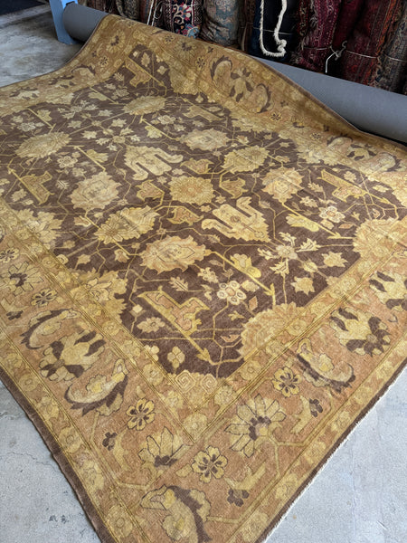 Large vintage Agra rug with blossom vine pattern on a milk chocolate ground.