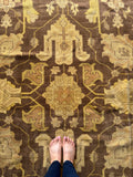 Detailed view of Agra rug vine and blossom design.
