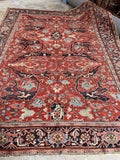 Large antique Heriz rug with bold floral design and turtle motif border

