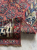Corner detail of antique Persian Kurdish runner with navy and ivory tribal border