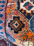 Antique Persian Kurdish bag face scatter rug center medallion closeup

