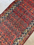 Antique Persian Kurdish runner draped showing brick red field and navy tribal border