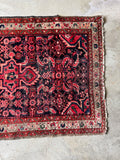 vintage persian Malayer accent rug with tribal motifs showing worn side