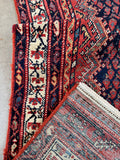 Back of vintage Persian Malayer runner rug showing hand knotted wool on cotton foundation