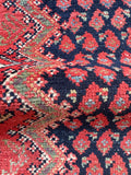 close up of vintage Persian runner rug showing navy red and ivory floral chevron detail