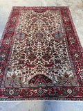 Full view of 1920s northwest Persian Heriz rug with geometric medallions.
