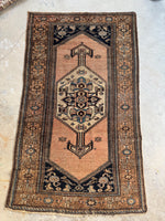 Antique 1920s Persian rug with peachy blush ground and center-poled medallion.