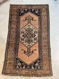 Antique 1920s Persian rug with peachy blush ground and center-poled medallion.