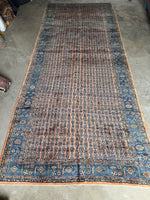 Handwoven Sarouk rug with small-scale paisley designs in a repeating linear pattern