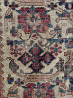 Close up view of worn antique Afshar rug handwoven with vegetable dyed wool.