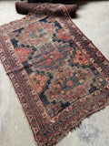 5x6 worn Persian Afshar rug with stacked tribal medallions and softened navy blue field.