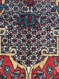 Eight-pointed star motifs symbolizing happiness on Persian rug.