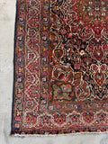 Antique Bakhtiari rug with geometric medallion, hand knotted Persian wool rug in rich red and blue.