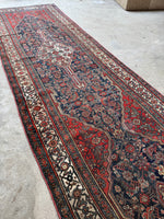 Persian Bibikabad runner with medallions filled with Herati motifs and rich detail.