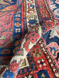 Close up of wool texture and color story of an antique Persian Bidjar rug.