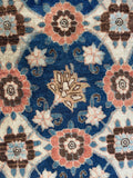 Close up of an antique Veramin Persian rug with balanced all-over floral pattern.
