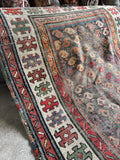 Hand-knotted Caucasian rug measuring approximately 3'x5' with an authentic distressed, shabby chic look.