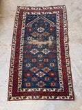 1920s hand-knotted wool rug showing a central devotional wear pattern from kneeling.