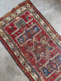 Hand knotted antique prayer rug with protective S-hook border, tribal wool carpet.