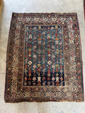 Handwoven antique Caucasian rug from the 1880s featuring tribal geometric motifs and vegetable dyed wool.
