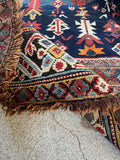 View of weave texture of an antique Caucasian rug with personality featuring French blue tones, tribal pattern, and aged character.