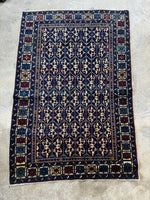 Deep blue field on antique Caucasian rug.