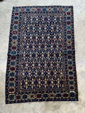 Deep blue field on antique Caucasian rug.