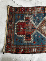 Handwoven Caucasian rug with strong tribal and symbolic design.