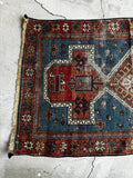 Handwoven Caucasian rug with strong tribal and symbolic design.