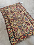 Yellow antique Caucasian wool rug with tribal paisley motifs, worn late 1800s hand knotted accent rug.