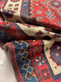 Close up detail of antique Caucasian runner displaying vegetable dyed wool and woven texture.