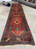 Antique Caucasian runner with rust red ground and sky blue border in excellent vintage character.