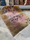 Lavender ground Chinese Art Deco rug with simple border and blue accents.