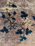 Detail of navy blue vine and floral motif on lavender ground.