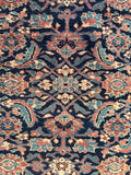 Close up of Herati fish pattern and flowerheads in an antique Ferahan Mahal rug.