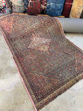 Antique Persian Ferahan rug from the 1880s with ivory medallion and detailed floral field.