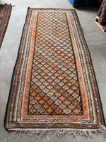 Flat weave runner featuring a hypnotic grid of tribal motifs.