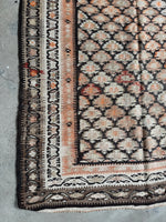 Corner view of century-old featherweight flat weave runner.