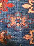 Detailed shot of vegetable-dyed wool texture and natural color variations on an antique rug.