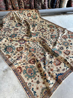 Ivory ground rug with interlocked design and rich colors.