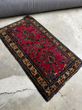 Hand-knotted wool area rug woven in the 1930s with saturated, natural vegetable dyes.