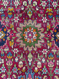 Saturated color detail in antique Persian rug pattern