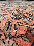 Large Antique Persian Rug in coral and navy featuring an allover floral pattern and sturdy handmade construction.