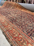 Antique Persian rug with navy blue field and intricate small-scale motifs.