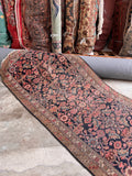 Antique Persian runner capturing the muted color palette and floral design.